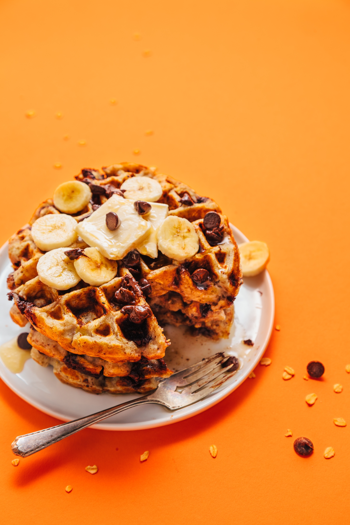 Stack of Chocolate Chip Banana Bread Waffles with a bite cut out