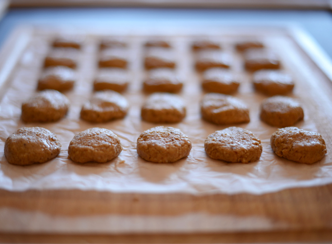 Batch of Raw Vegan Peanut Butter Cookies on a piece of parchment paper