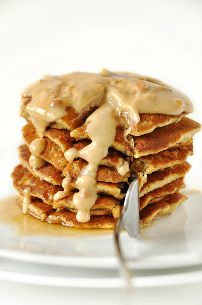 Using a fork to grab a big bite from a stack of Vegan Peanut Butter Pancakes