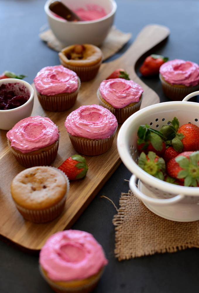 Batch of our Strawberry Beet Cupcakes recipe surrounded by ingredients used to make them