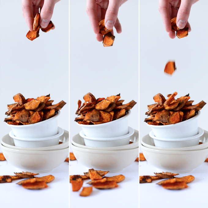 Dropping a handful fo Spicy Sweet Potato Chips into a bowl for a game day snack