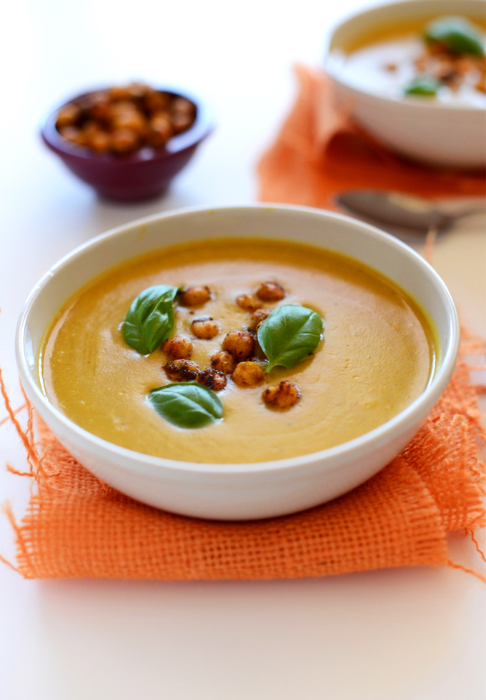 Bowl of Sweet Potato Coconut Curry Soup topped with fresh basil and Crispy Baked Chickpeas