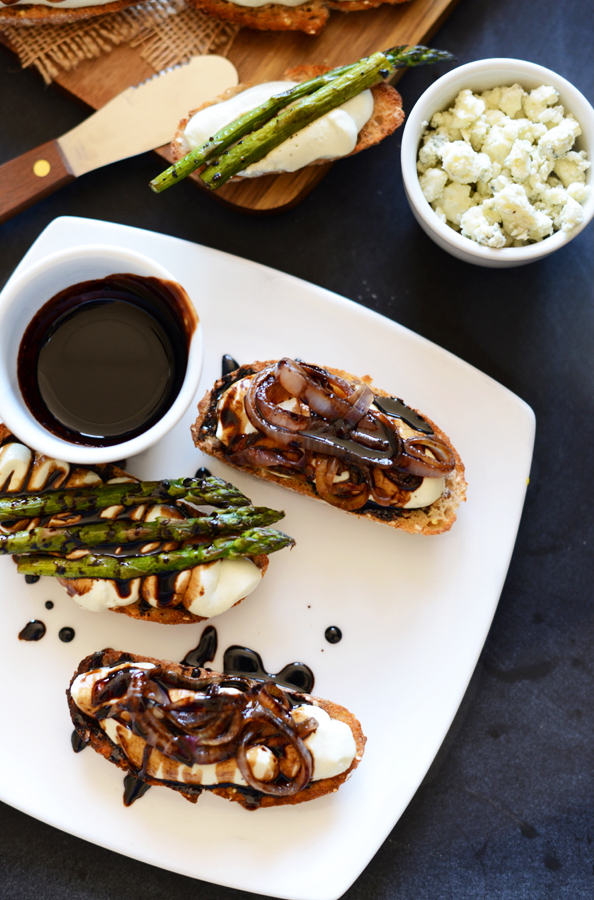 Plate of Bleu Cheese Balsamic Bites topped with caramelized onions and asparagus