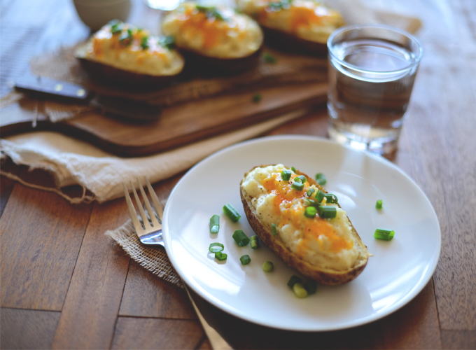Plate and cutting board of healthier Twice-Baked Potatoes made with cauliflower