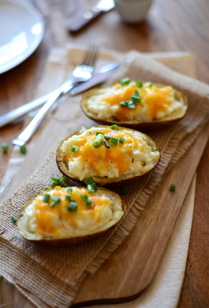 Row of Cauliflower Twice Baked Potatoes topped with cheddar and green onion