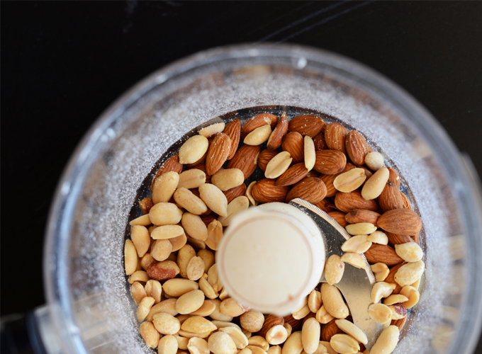 Food processor filled with peanuts and almonds for making No-Bake Cookies