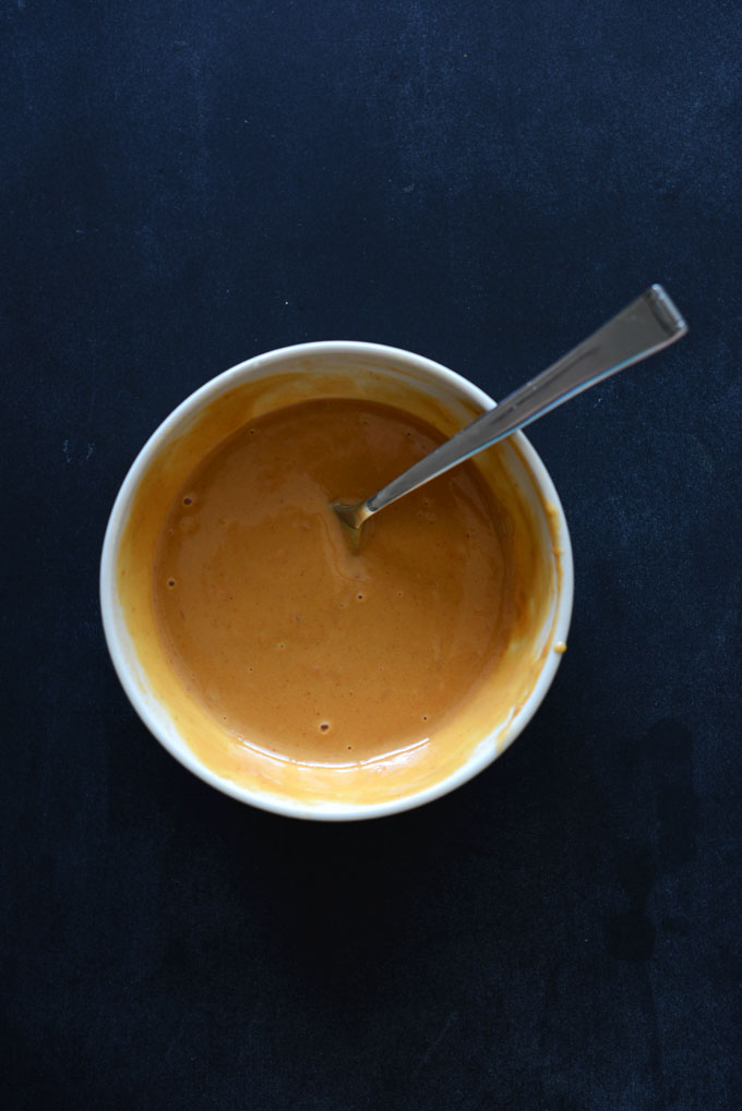 Bowl of peanut sauce for topping Curry Roasted Carrots