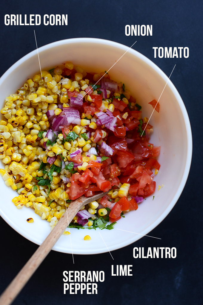 Bowl of grilled corn, onion, and tomatoes for making a simple Corn Salsa