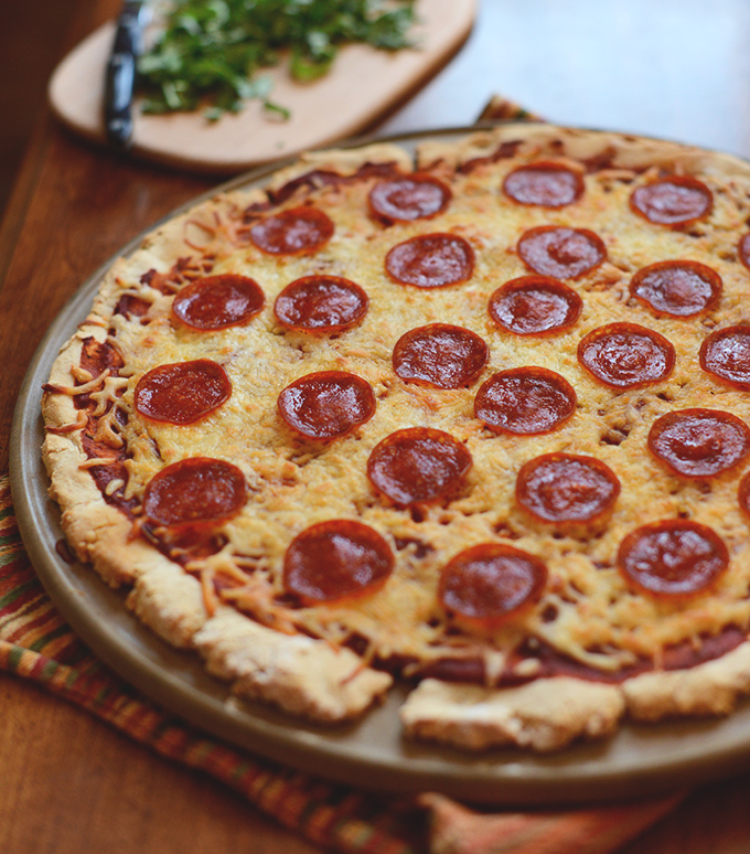 The Best Gluten-Free Pepperoni Pizza resting on a pizza stone