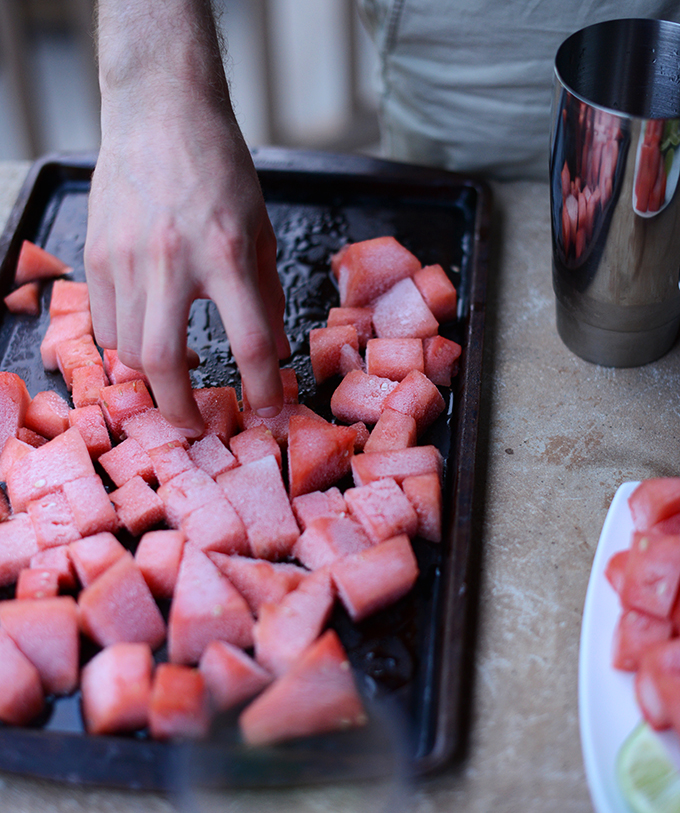 Grabbing a handful of watermelon ice cubes to add to homemade margaritas