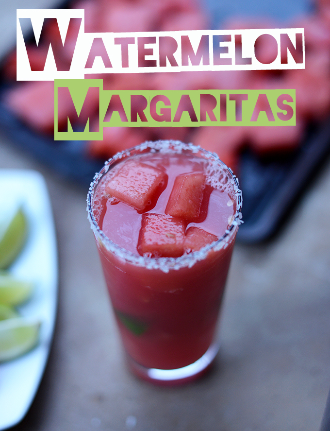 Tall glass of our Watermelon Margarita recipe with alongside fresh limes and watermelon