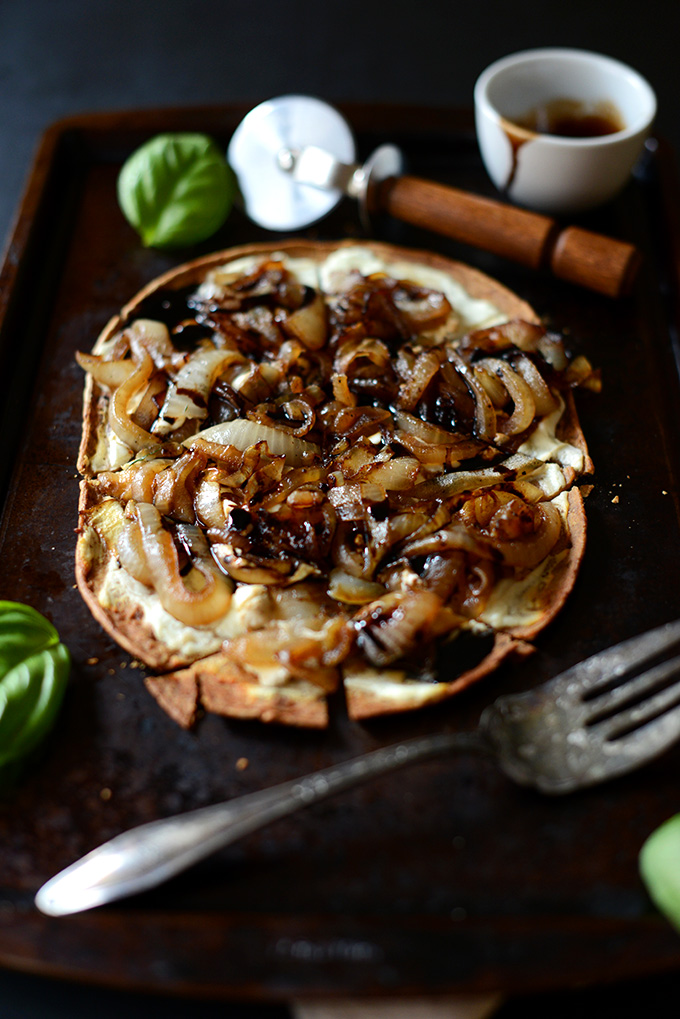 Baking sheet with a pie of our Goat Cheese Caramelized Onion Pizza recipe