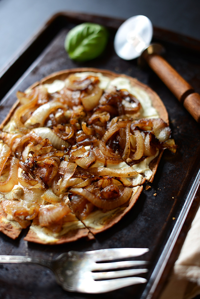 Baking sheet with slice Goat Cheese and Caramelized Onion Vegetarian Pizza