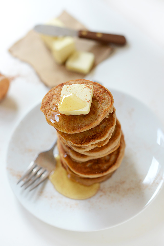 Stack of Sopapilla Pancakes with honey and slabs of vegan butter in the background