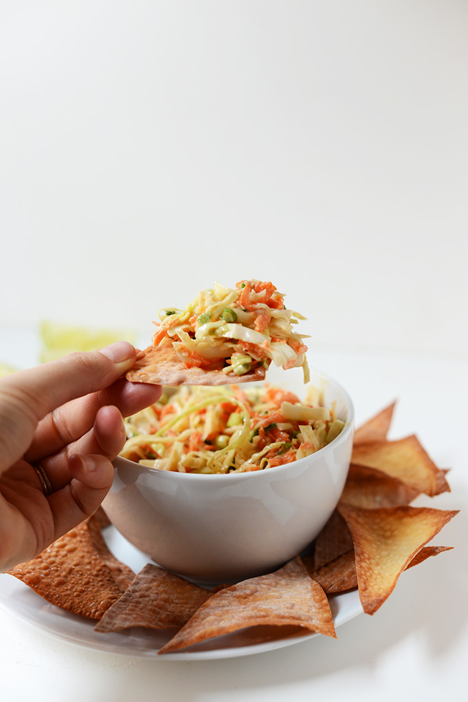 Using a chip to scoop up a bite of Creamy Thai Slaw