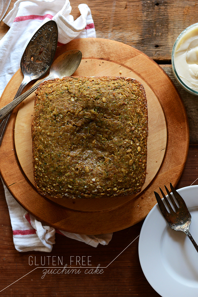 Loaf of Gluten-Free Zucchini Cake with a bowl of frosting on the side