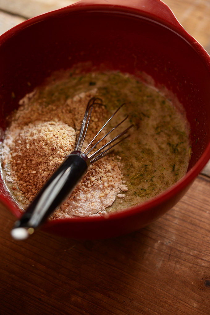 Using a whisk to mix together batter for Gluten-Free Zucchini Cake