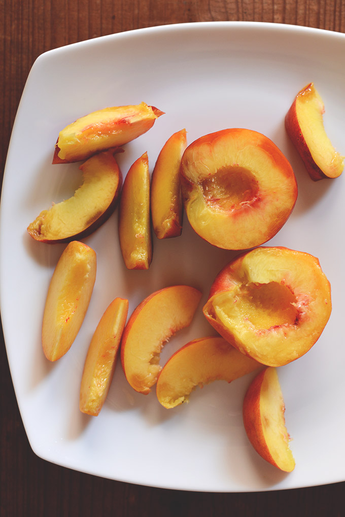 Plate of fresh peaches for making a vegan chia smoothie