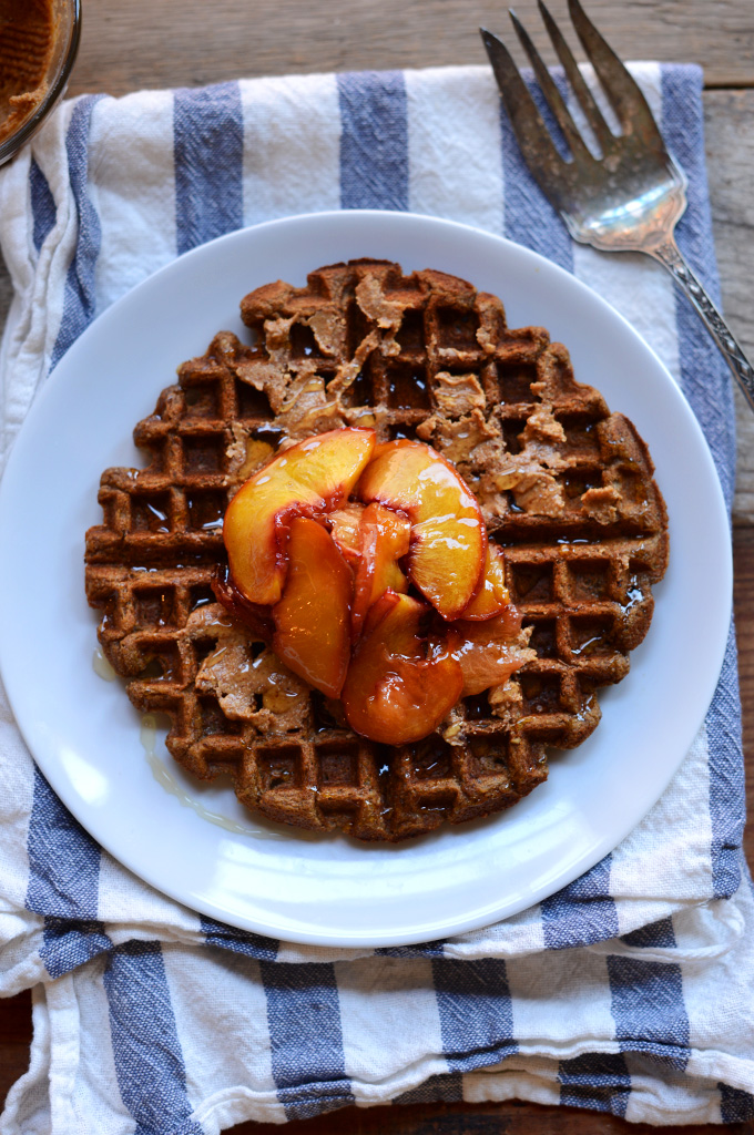 Whole Grain Vegan Waffle topped with maple syrup and roasted peaches