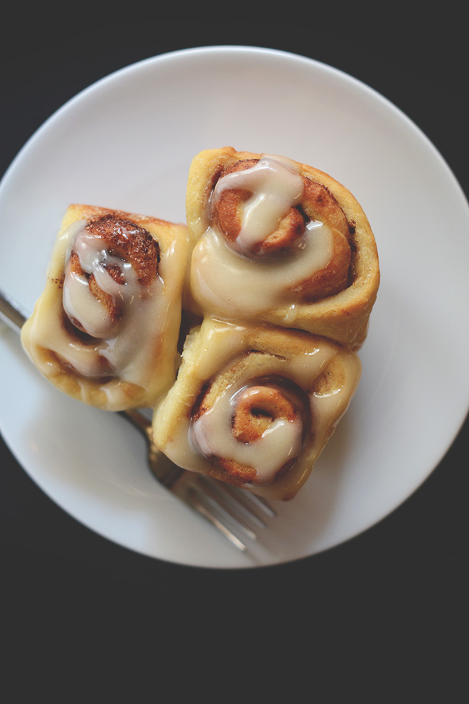 Plate of three Vegan Cinnamon Rolls topped with icing