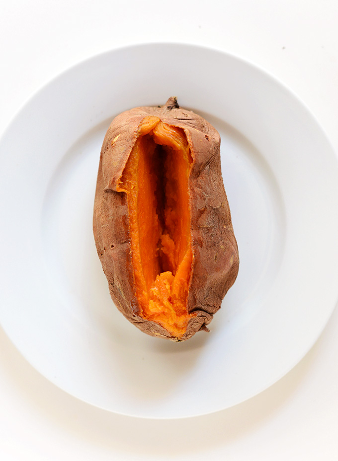 Plate with a freshly baked and sliced open sweet potato