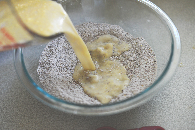 Pouring wet ingredients into dry for Blue Cornmeal Waffles