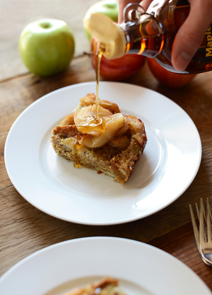Drizzling maple syrup onto a slice of our Cinnamon Apple French Toast Bake