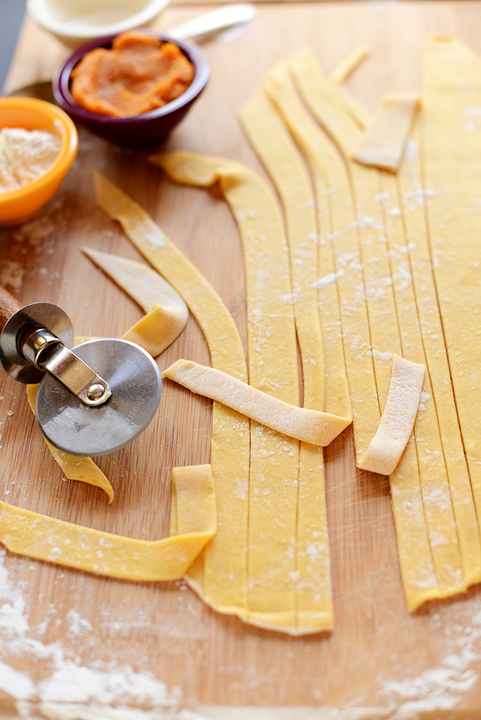 Strips of From Scratch Pumpkin Pasta on a cutting board