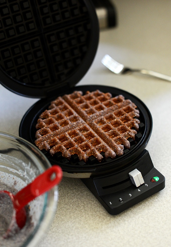 Freshly cooked Gluten-Free Vegan Cornmeal Waffle in a waffle iron