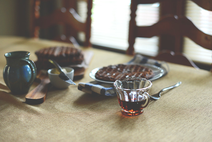 Table with Gluten-Free Waffles, syrup and butter for a delicious breakfast
