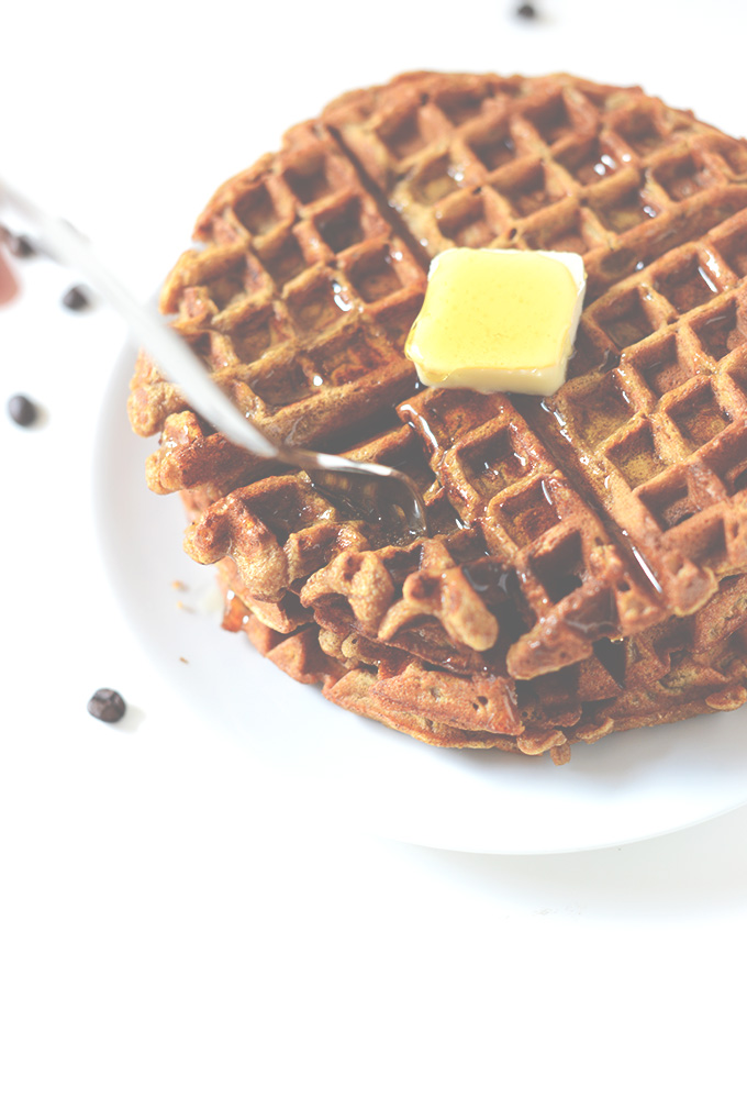Using a fork to grab a bite of delicious Pumpkin Spice Waffles for breakfast
