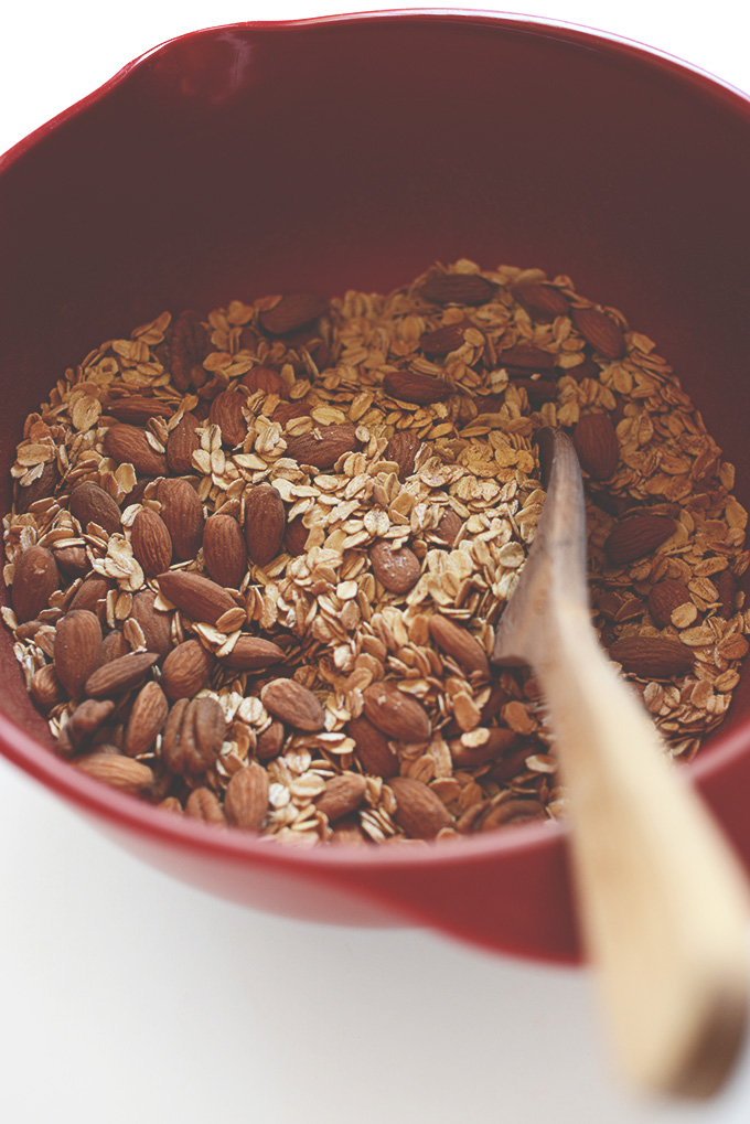 Mixing oats and almonds in a bowl for homemade Sweet Potato Granola