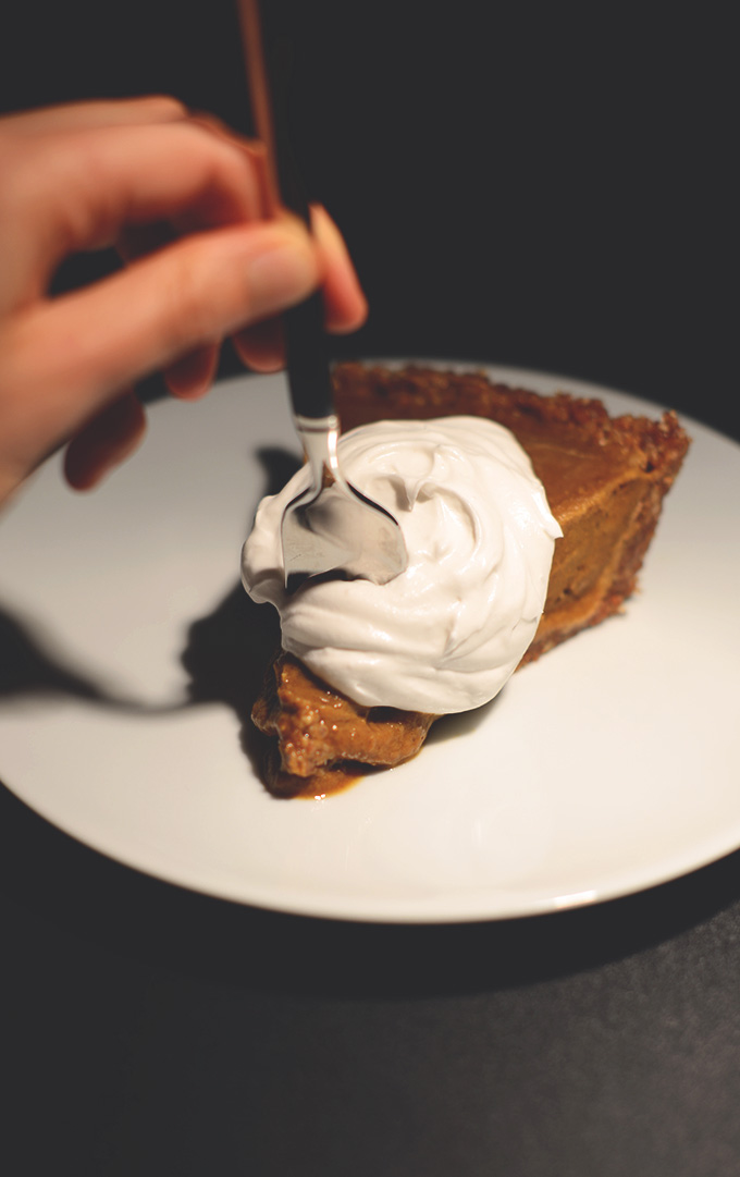 Grabbing a bite of Creamy No-Bake Vegan Pumpkin Pie topped with coconut whipped cream