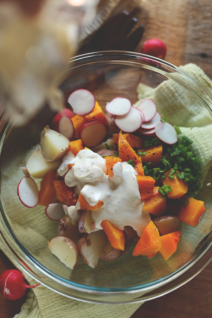 Bowl of Easy Butternut Squash Potato Salad with a dollop of dressing on top
