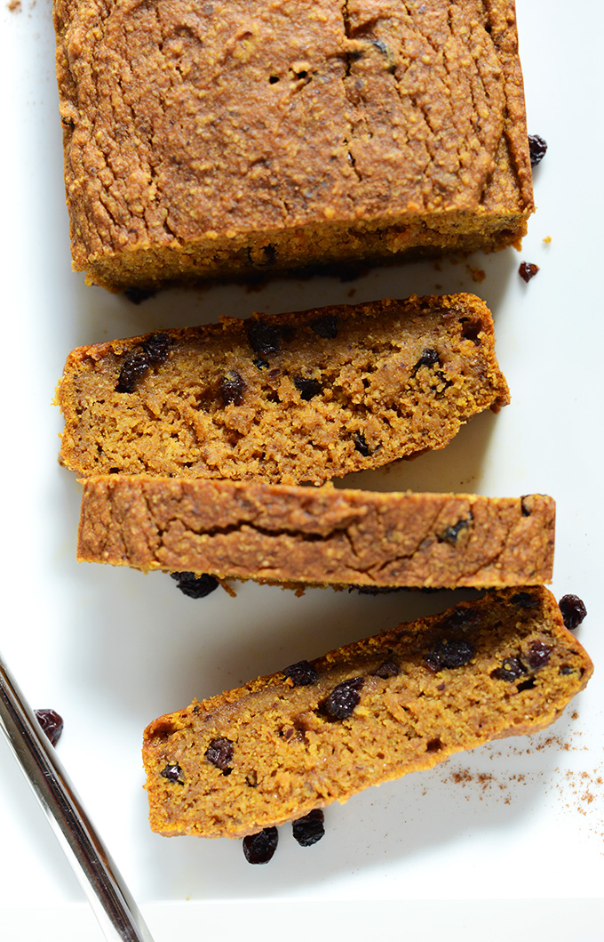 Partially sliced loaf of our Easy Vegan Pumpkin Bread made with dried currants