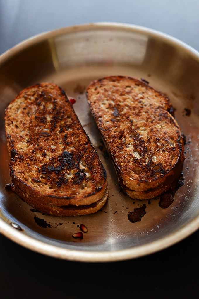 Making Grilled Almond Butter Chocolate Pomegranate Sandwiches in a skillet
