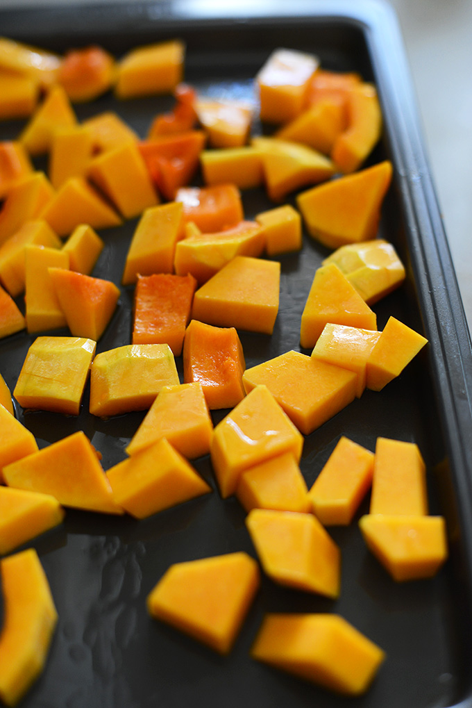 Baking sheet with cubed butternut squash for roasting