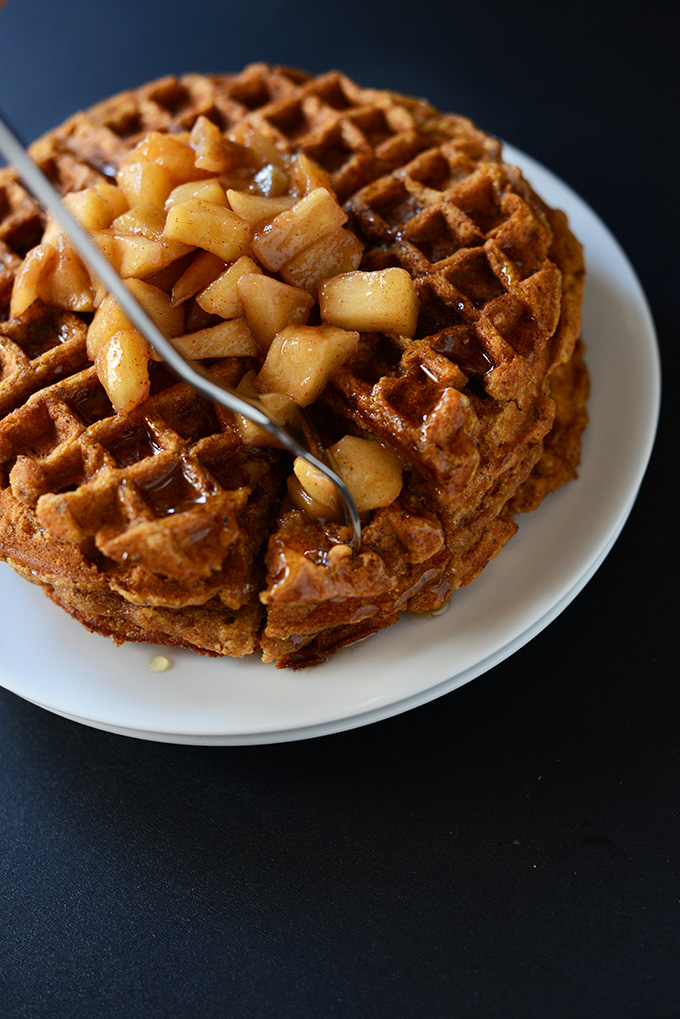 Using a fork to grab a bite of double stacked Cinnamon Apple Waffles