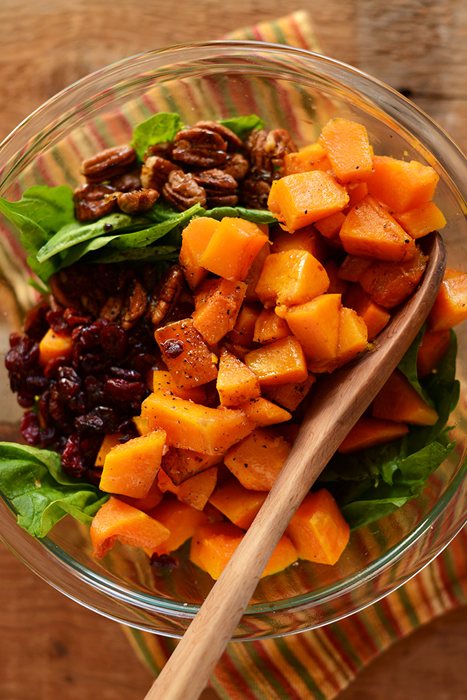 Big bowl of Roasted Butternut Squash Salad with dried cranberries and caramelized pecans
