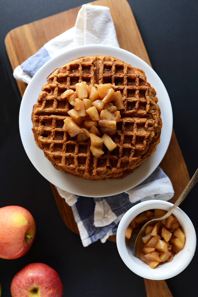 Plate of Vegan Apple Waffles and small bowl of extra cinnamon apples