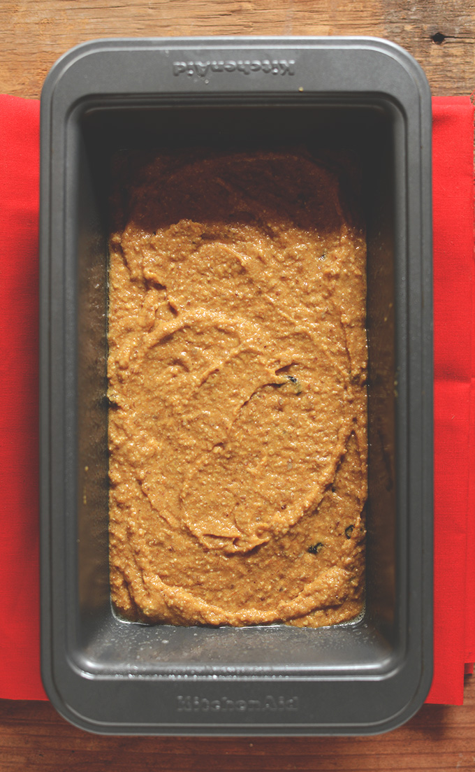 Loaf pan filled with batter for our Vegan Pumpkin Bread recipe