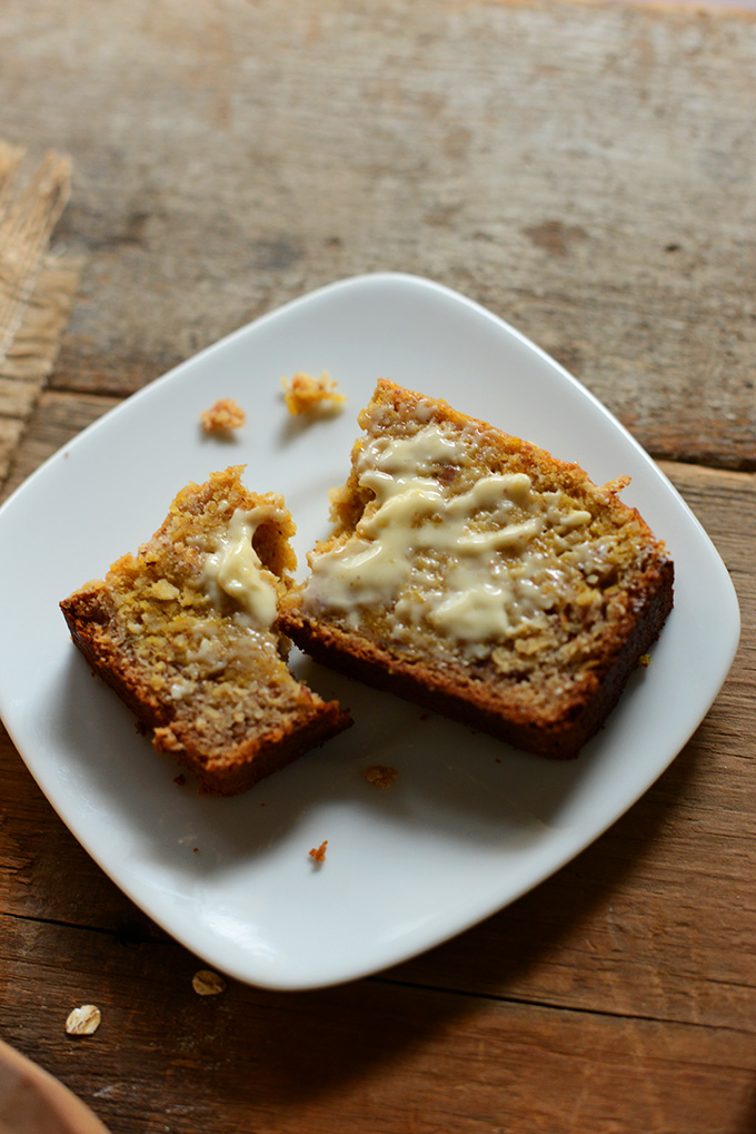 Plate with a slice of Butternut Squash Banana Bread smeared with butter