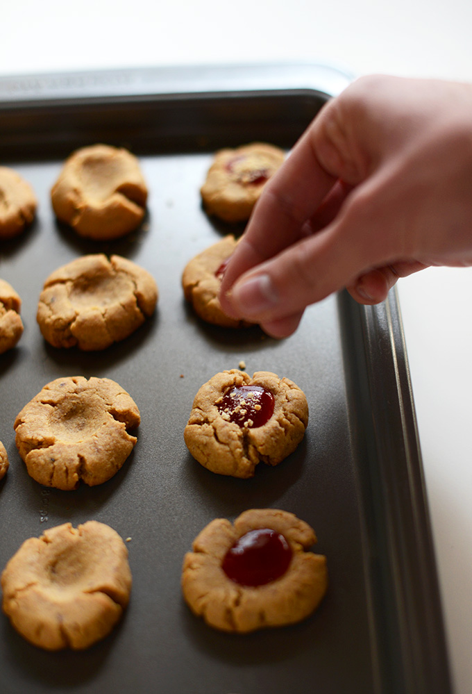 Sprinkling crushed graham cracker onto Vegan Thumbprint Cookies