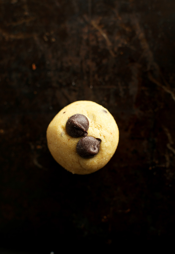 Ball of Gluten-Free Chocolate Chip Cookie dough topped with two chocolate chips
