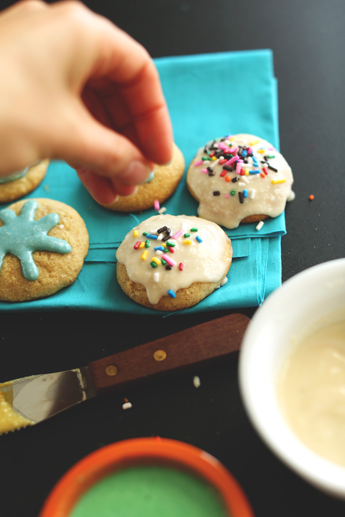 Adding sprinkles on top of our Gluten-Free Sugar Cookies with Vegan Frosting