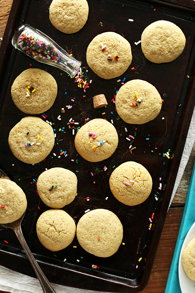 Baking sheet with rainbow sprinkles and a batch of our Gluten-free Sugar Cookies recipe