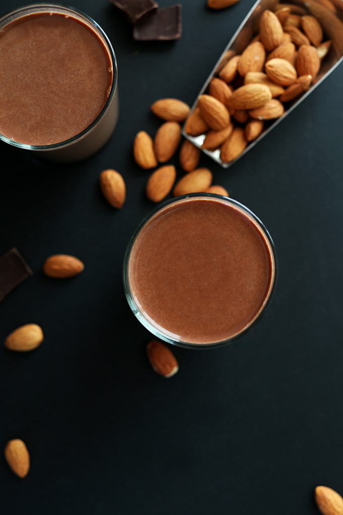 Dark chocolate, almonds, and glasses of homemade Chocolate Almond Milk