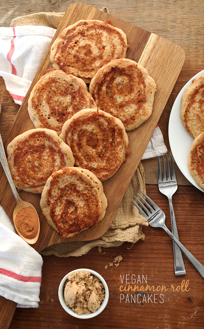 Batch of delicious Vegan Cinnamon Roll Pancakes on a cutting board