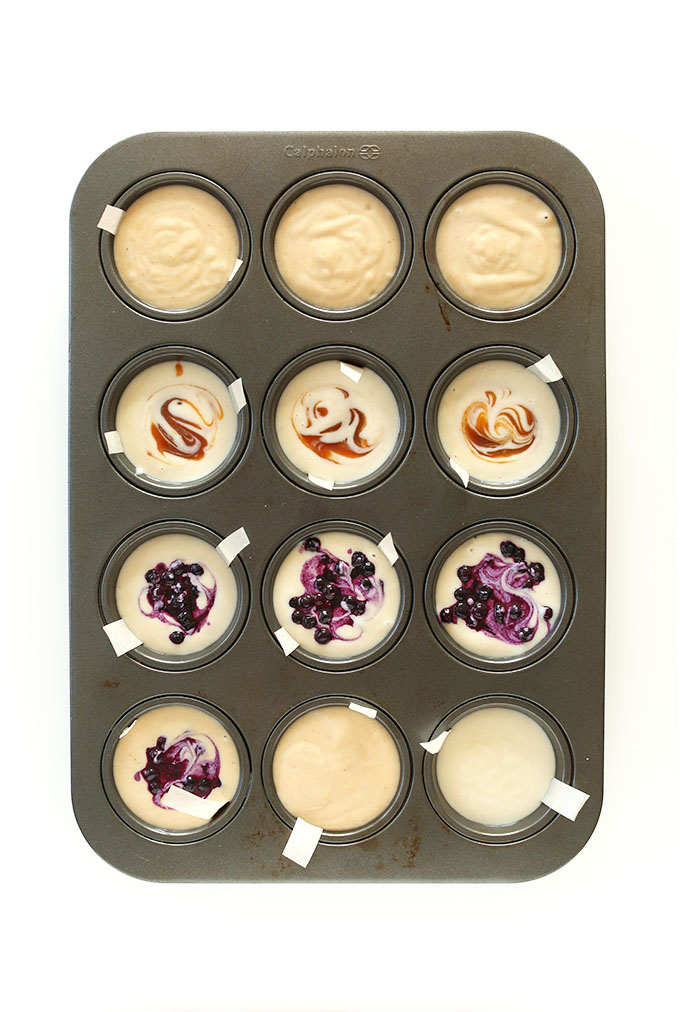 Assorted flavors of Mini Vegan Cheesecake Bites setting up in a muffin tin
