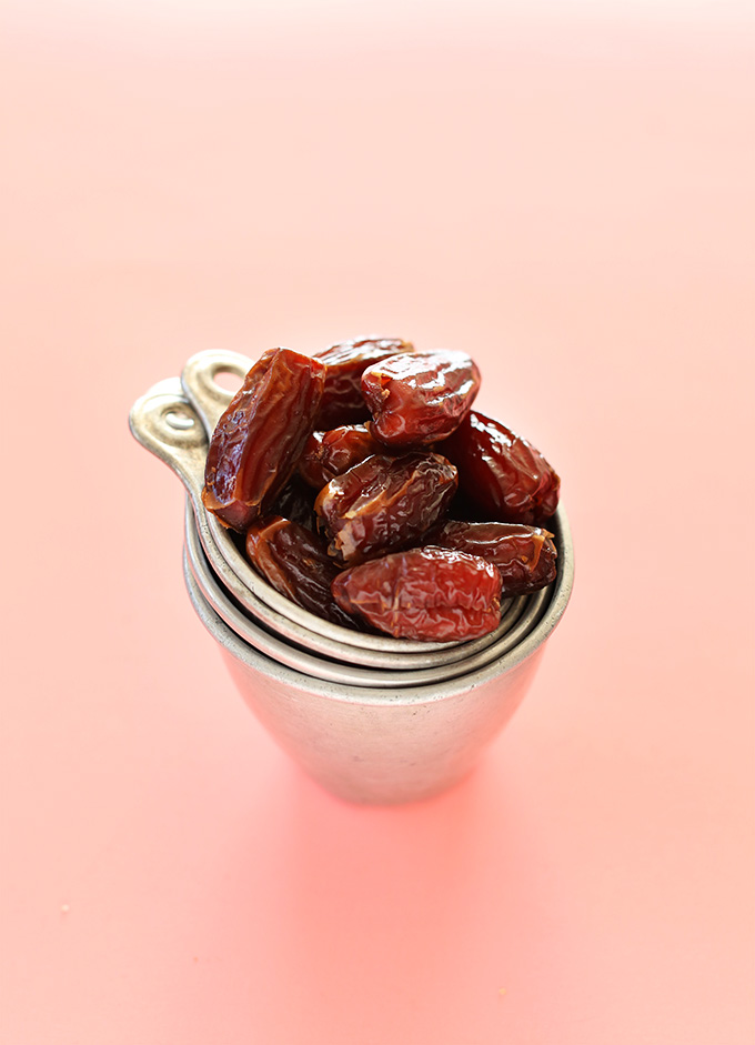 Stacked measuring cups filled with fresh dates